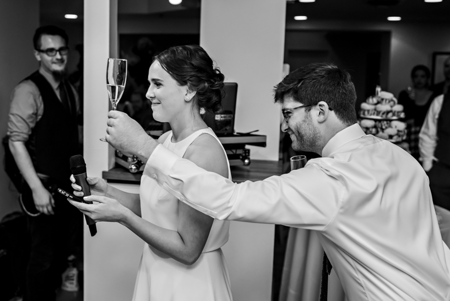 A bridesmaid's husband shows up with champagne during her speech.
